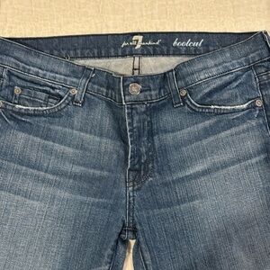 7 for all mankind boot cut jeans with crystal embellishment in rips in pockets.